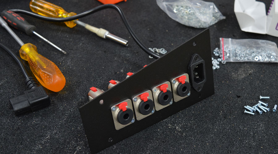 Loaded interface panel with D Series locking TRS jacks and an IEC power inlet.